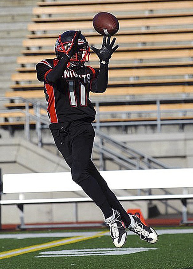 A Kent youth football player catches the ball during a game. The uniforms will be changing this upcoming season.
