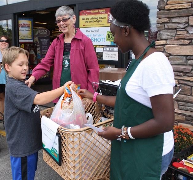 Covington Mayor Margaret Harto smiles as Moses Sullivan