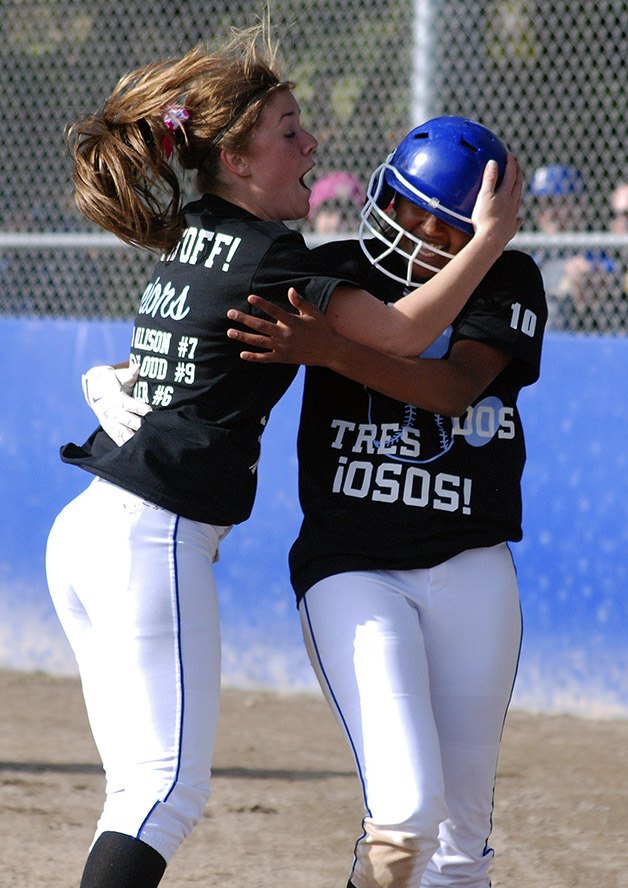 Tahoma’s Courtney Cloud celebrates with Mia Corbin after Corbin scored the tying run against Kentwood April 30.