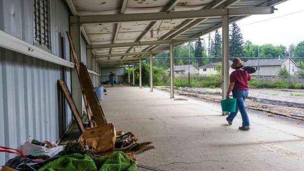 Volunteers help clean the old driving range Tuesday at the former Elk Run Golf Course to make way for the future storage space for the Elk Run Farm.