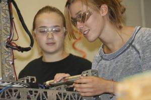Tahoma Robotics Club President Mackenzie Dowel works on the robot while senior Emily Burlison observes. Dowel hosted an all-girls robotics competition for her senior project.
