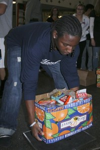 Marcellis Dodson places a box of food on the scale Dec. 4 at Kentwood High School during the Munch Madness event.