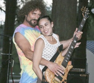 Lynn Sorenson and Danielle DeBarr play bass together in the Magic Bus band during the Music in the Park series at Lake Wilderness Park Aug. 12.