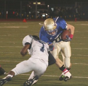 Tahoma junior running back Zach Browne lowers his shoulder as a Mount Rainier defender prepares to tackle him.