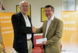 Brown & Haley President and CEO Pierson Clair hand delivered their membership check to WTC Tacoma President Anthony Hemstad to symbolically mark the quadrupling.