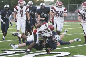 Kentlake's Stephon Vaifale is tackled by Auburn Riverside's defensive back Cameron Grad Friday