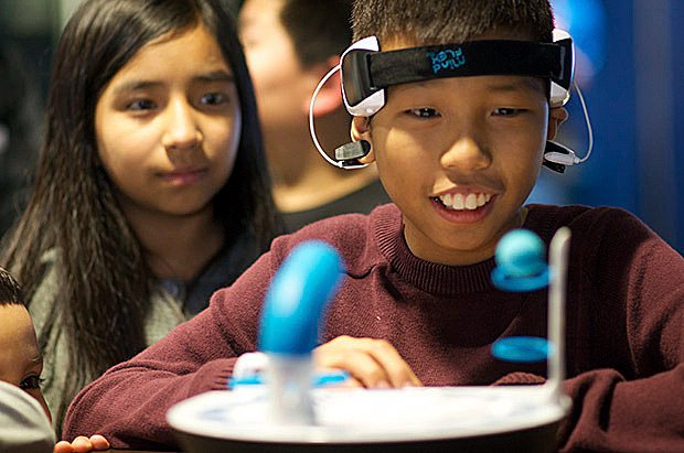 Nealin Becker plays a concentration game on interactive display at last year’s Kent School District’s Tech Expo.