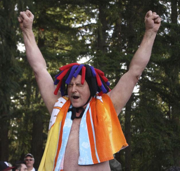 Polar plunge organizer Ted Strand cheers on the crowd as they prepare to jump into the 40 degree Lake Sawyer water Sunday on New Year's Day