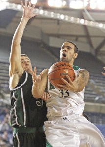 Kentwood’s Tre Tyler drives past Jackson’s Austine O’Keefe for two points in the 4A state championship game March 6 at the Tacoma Dome. The Conquerors took home their second state boys title in school history.