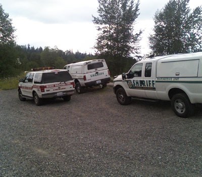 Emergency personnel assist five people stranded in the Green River Sunday