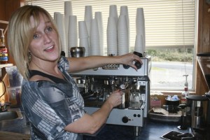 Beauty and the Beans manager Michelle Doyle makes white coffee inside of her drive-through espresso stand. It is the only independent drive-through espresso stand in Covington.