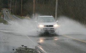 The heavy rains caused water over the road on 148th Avenue Southeast near the intersection of Southeast 256th Street from Big Soos Creek Sunday