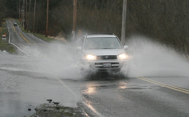 The heavy rains caused water over the road on 148th Avenue Southeast near the intersection of Southeast 256th Street from Big Soos Creek Sunday