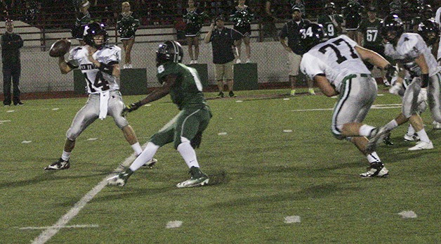 Kentwood quarterback Brian Campbell looks down field for an open player Friday during the Conks’ 35-14 win over Emerald Ridge.