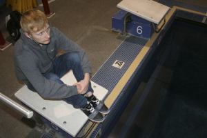 Kentlake senior Erik Fulmer sits inside the Covington Aquatic Center as he listens to Mozart