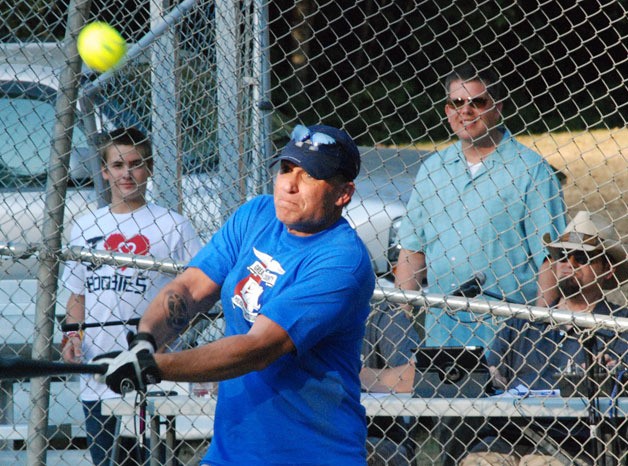 Maple Valley Police Officer Jeff Harmon gets a piece of ball Saturday