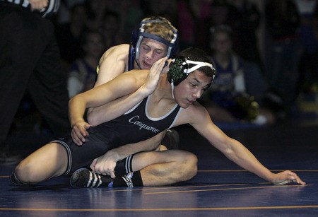 Tahoma's Steven Hopkins works to control the match against Kentwood's Ruben Nevejas in a 119 pound match on Dec. 9. It was the first league dual meet of the season for both teams.
