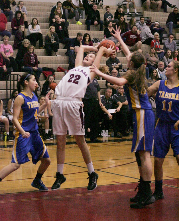 Sophomore Kylee Johnson goes up for a shot against a crowd of defenders Jan. 24 against Tahoma. The Falcons beat the Bears 42-36