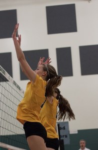 Freshman Emily Smith (left) and Sophomore Ginny Mehl go up for a block against Kentwood's offense Friday night.