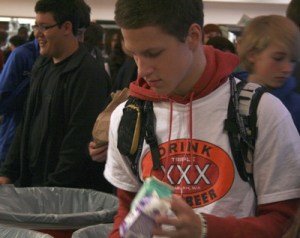 Tahoma Junior High student Matthew Griffith prepares to throw his milk carton into the recycling bin.