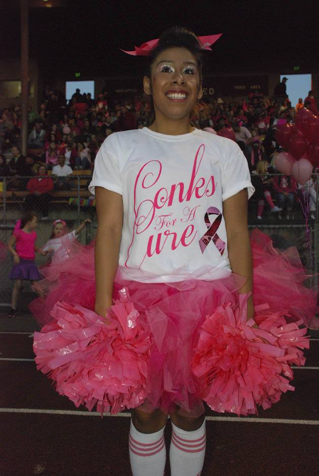 Kentwood cheerleader Lily Peabody-West is decked out in pink Conks For A Cure gear before the game against Kentridge Sept. 28.