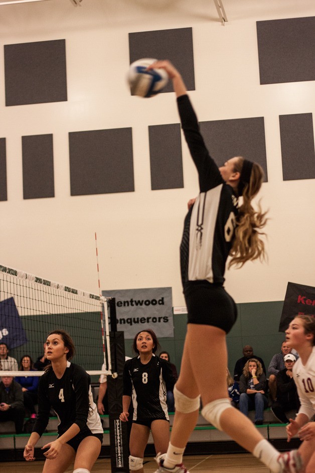 Lexi Lockhart spikes the ball for a point during Kentlake’s match against Curtis at the start of the 4A district  tournament in November.