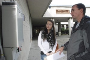 Tahoma senior Breanna Emmons listens to science teacher Mike Hanson explain how the new solar panel meter at the high school works.
