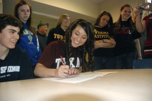 Tahoma High senior Sammii Jimenez signs on the dotted line Monday afternoon. Jimenez