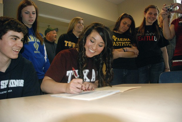 Tahoma High senior Sammii Jimenez signs on the dotted line Monday afternoon. Jimenez