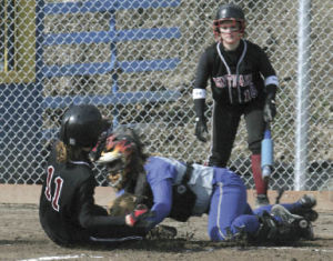 Kentlake’s Brianne Bilbrey slides home just ahead of the tag of Tahoma catcher Lauren Gazdik during Tuesday’s game. Kentlake went on to beat Tahoma