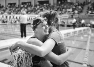 Kentwood’s Marley Prothero is hugged by a friend after winning the state 200 IM title in the Class 4A finals at Weyerhaeuser King County Aquatic Center in Federal Way.