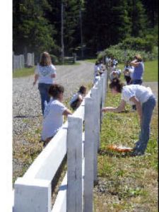 Painting fences was one of the community service tasks for participants in an LDS church youth conference last month.
