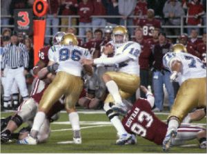 Washington State defensive end Kevin Kooyman (93) brings down a UCLA ballcarrier during a game last season. Kooyman