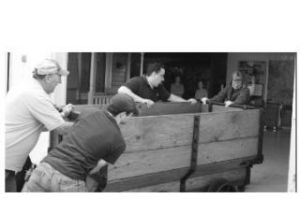 A refurbished coal car that was a Black Diamond mine workhorse long ago is wheeled into Renton History Museum by museum volunteers Wil Sampson