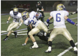 Tahoma’s Chris Marangon (23) rushes down the left sideline for a 28-yard gain on a fake punt during Thursday night’s game against Kentwood at French Field.