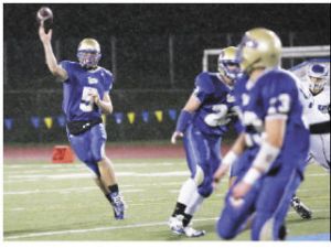 Tahoma quarterback Heyden Johnson (left) uncorks a pass to wide receiver Chris Marangon (No. 23) during Friday night’s game against Federal Way. Tahoma
