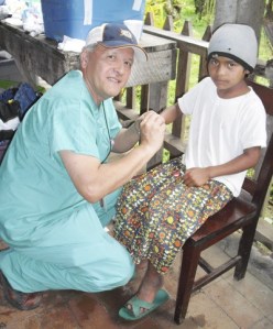 Esmilse gets school shoes from Dave Maniquis during the Corner of Love mission in June to San Ramon and the surrounding region in Nicaragua.