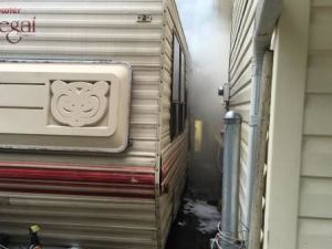 Firefighters worked to stop flames from spreading to a nearby home from a trailer that was on fire. Courtesy photo from the Kent Regional Fire Authority.