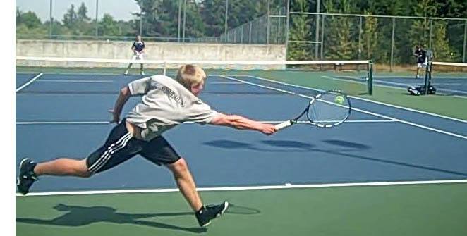 Kentwood senior Patrick Daly goes to return his opponent's shot during a match.