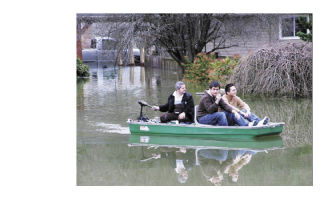 A boat gets these residents from their homes just off State Route 169 to where they parked their cars on drier land.