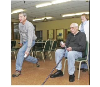 Allison Scott (left) takes a break from her duties as director of senior services at the community center. Fred Englehardt and Linda Worley
