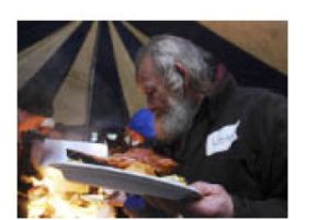 A guest fills his plate at a holiday party hosted by Mountain Vineyard Christian Fellowship.