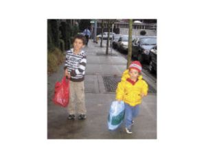 Marcus and Tate Dawson carry bags of donated pajamas into Treehouse.