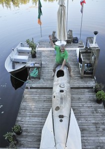 Keith Lanan on the dock at his Lake Kathleen home with the 13-foot drop tank that he fished out of lake this summer. LEAH ABRAHAM