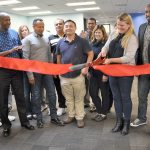 Brooke Steger, Pacific Northwest Uber general manager, joined by Uber employees and driver-partners, cuts a ribbon to mark the open of Uber&rsquo;s Greenlight Hub in Tukwila on Nov. 11. HEIDI SANDERS/Tukwila Reporter