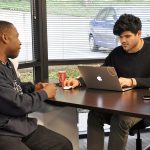 Uber expert Oscar Romero, right, helps Gary Tarver, of Tacoma, sign up to become an Uber driver-partner at the new Greenlight Hub in Tukwila. The hub, which moved from Pioneer Square in Seattle, provides Uber driver-partners with in-person support and assistance. HEIDI SANDERS/Tukwila Reporter