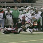 Kentwood senior Darius LuBom gets dragged down by Kentlake junior Tony Heimann II Friday at French Field. The Conks won 36-0. SARAH BRENDEN, The Reporter