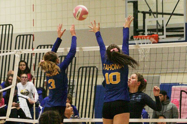 Freshman Sophia Meyers and sophomore Layne Cooper block a shot from the Mount Rainier Rams during a regular season match. Sarah Brenden, The Reporter