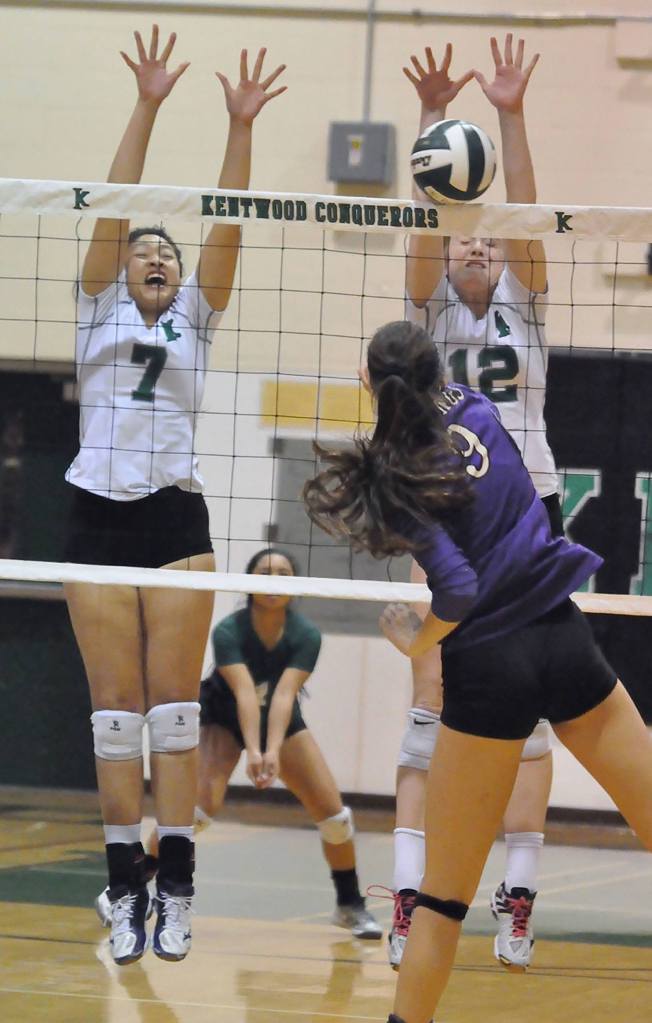Kentwood&rsquo;s Alvina Ngo, left, and Erin Gould attempt to block a shot by Puyallup&rsquo;s Kaitlin Sugai during district action Nov. 5 in the Conquerors gym. RACHEL CIAMPI, The Reporter