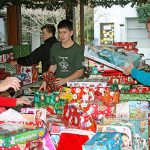 Volunteers wrap toys for the Toys for Joy program.